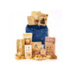 A gourmet gift basket set featuring a navy blue drawstring bag with silver star details, surrounded by an assortment of packaged snacks, cookies, and nuts on a clean white background.