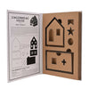 Gingerbread house building kit with cardboard pieces and instructions on a white background
