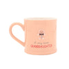 A light peach ceramic mug with a handle, featuring a small gingerbread person illustration and the text 'A very sweet GRANDDAUGHTER' printed on the front, set against a plain white background.