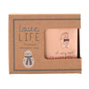 A peach-colored stoneware mug with a gingerbread man charm and 'A very sweet GRANDDAUGHTER' text, presented in its brown kraft paper gift box with a snowman illustration.