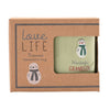 A boxed engraved stoneware mug with a kraft paper presentation box. The mug is pale green and features a snowman design with the words 'Wanderful GRANDSON.