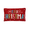 A rectangular red textured throw pillow featuring the words 'MERRY CHRISTMAS' in multicolored letters with small white dot accents, shown against a plain white background.