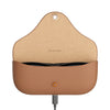 A tan leather charging case for Ray-Ban Meta earbuds, shown open with the earbuds inside and a charging cable plugged into the bottom port. The interior is a natural tan color with the brand name 'RAY-BAN META' printed on it.