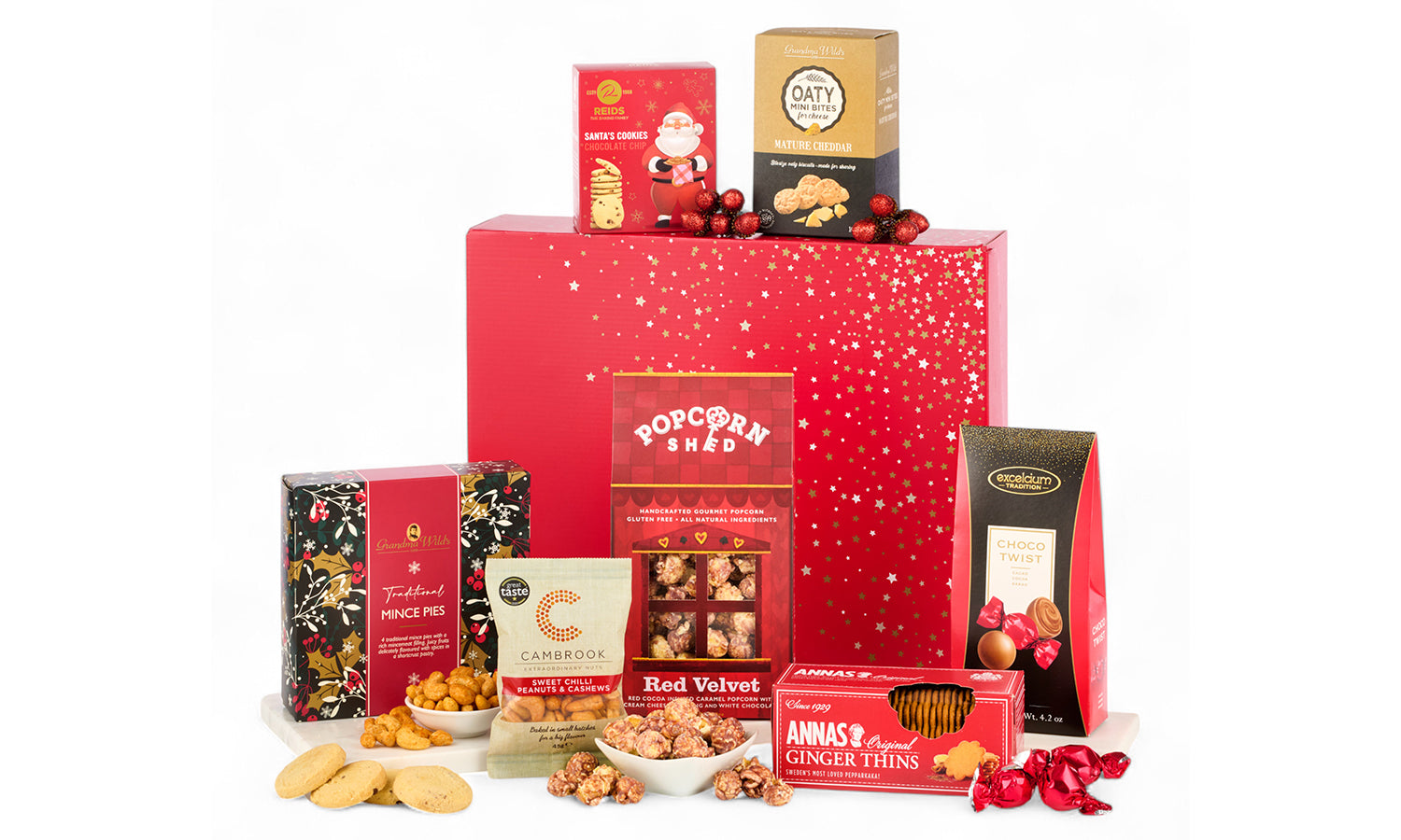 Red giftbox with star design surrounded by sweet and savoury treats