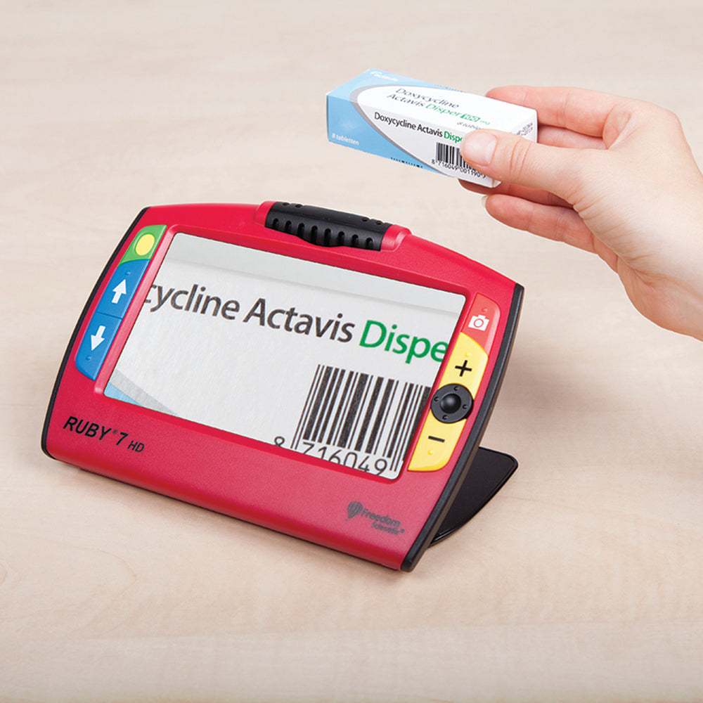 Angled view of magnifier showing medication box on screen
