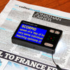 HandyReader HD video magnifier magnifying newspaper text in yellow on blue format