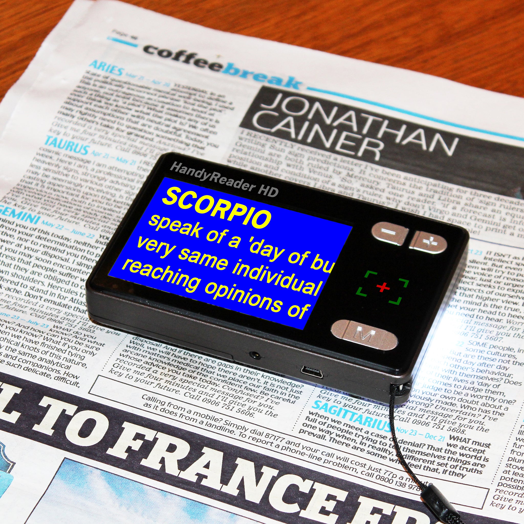 HandyReader HD video magnifier magnifying newspaper text in yellow on blue format
