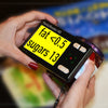 A HandyReader HD video magnifier showing enlarged nutritional information on a jar in the black on yellow format