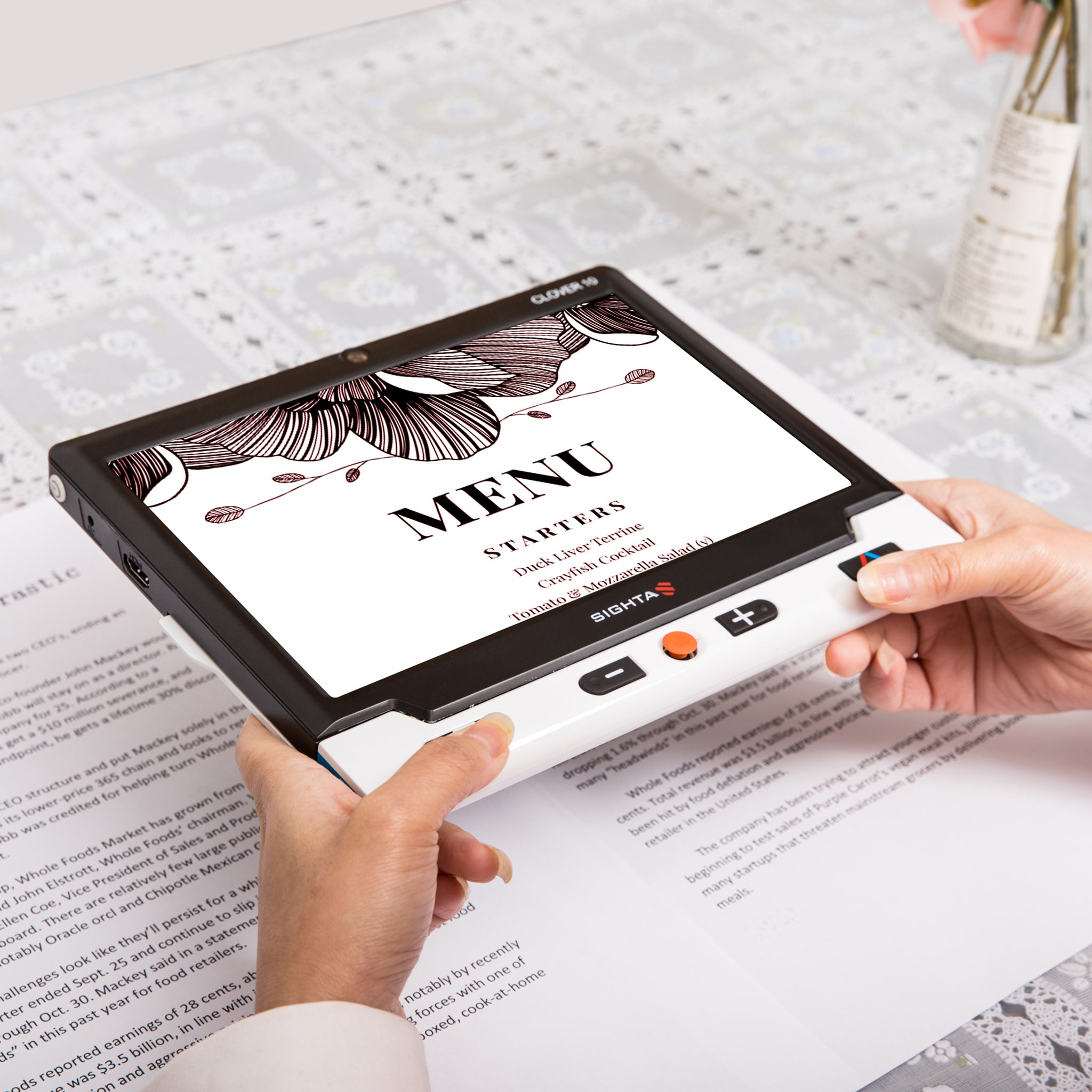 Clover 10 portable video magnifier showing enlarged menu text on screen