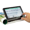 A person pressing the 'enlarge' button on a Compact 8 HD which is magnifying text in a magazine .