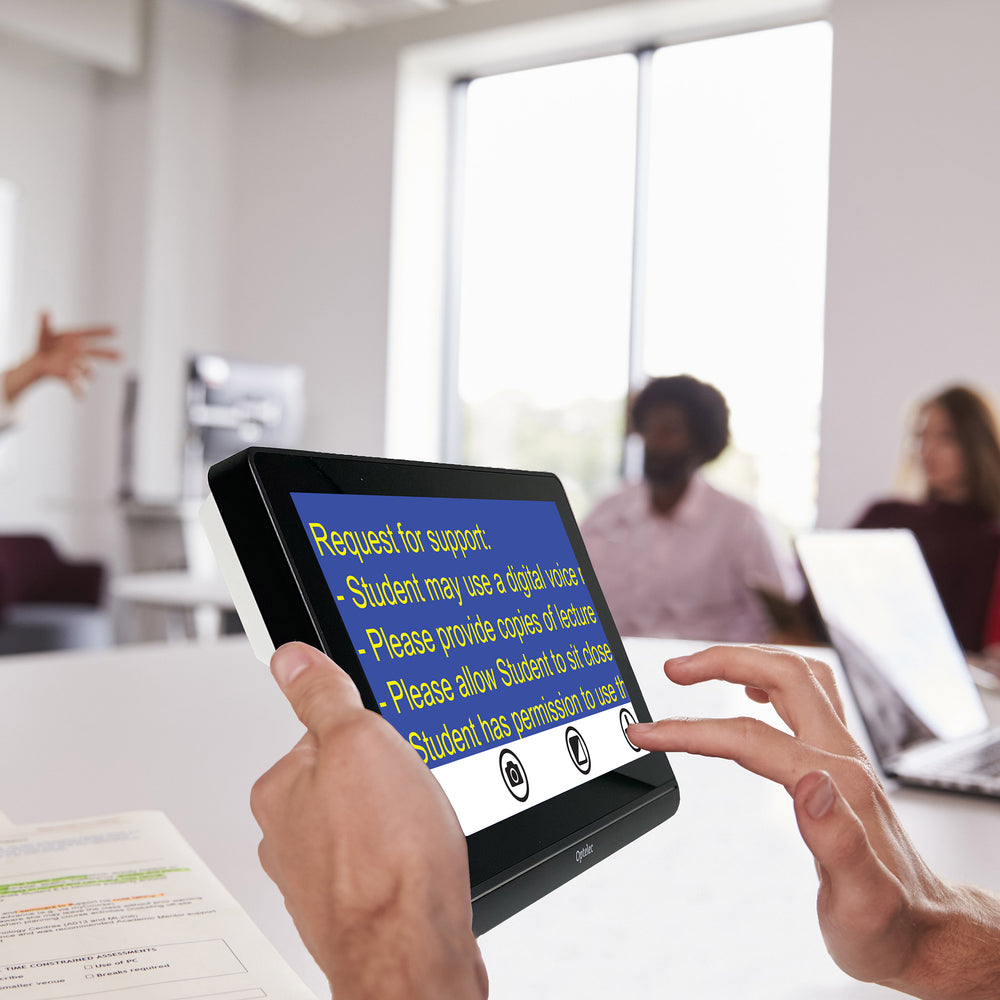 A person holding a Compact 8 HD in a class to magnify information for students in yellow on blue format