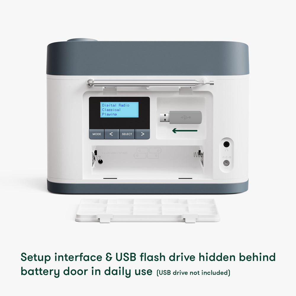 Relish Radio & Music Player with setup interface and USB flash drive hidden behind battery door on a white background