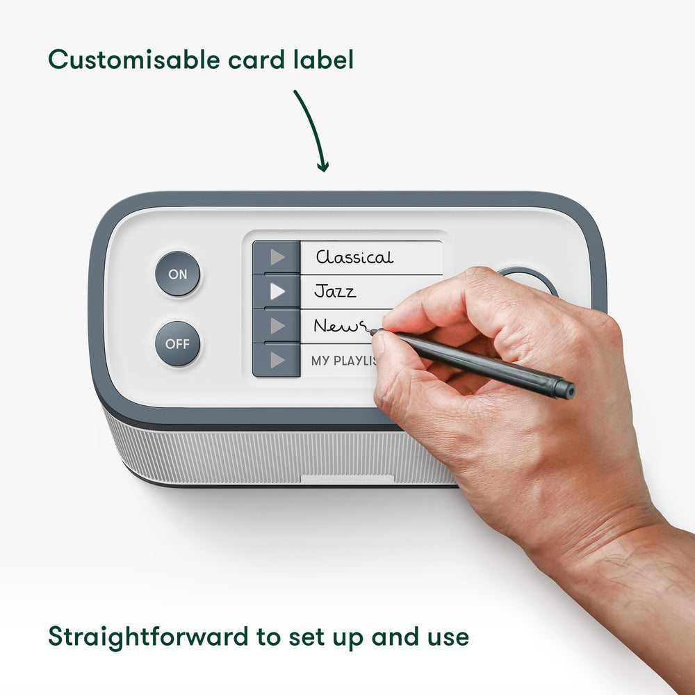 Hand using a stylus to write on a the Relish Radio & Music Player with customizable card label feature.