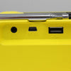 Close-up of a yellow radio with USB and DC 5V ports.