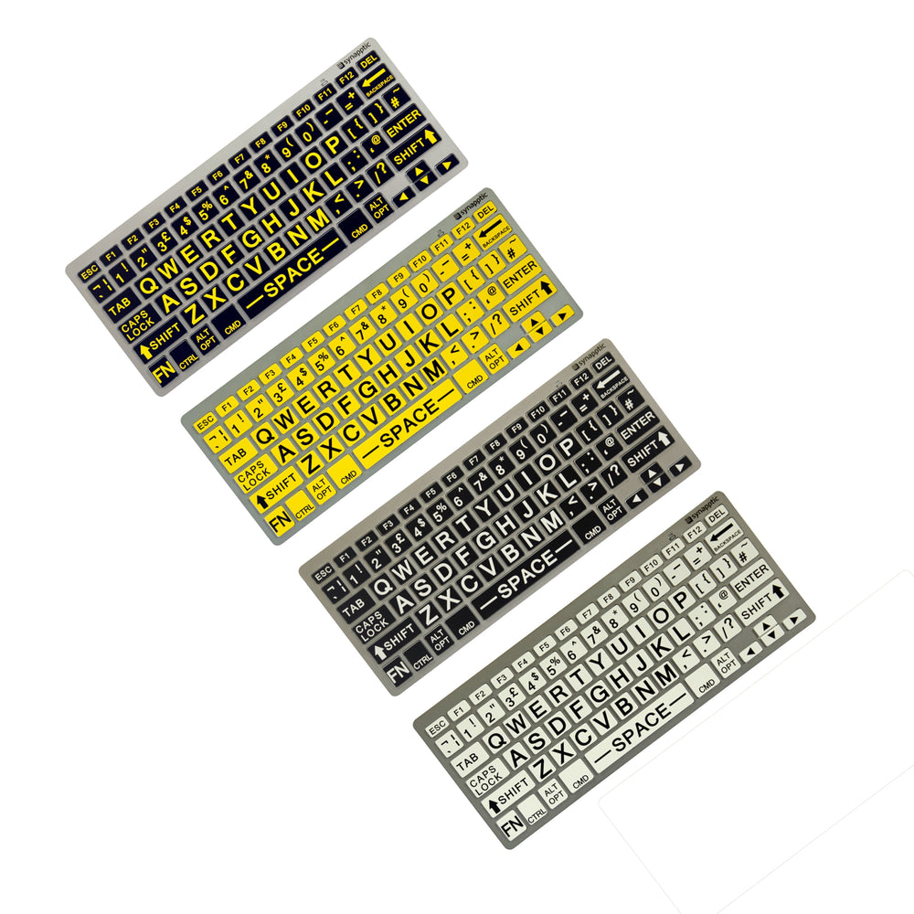 Four large print keyboards. Top left white text on black ; then; black text on yellow;  then; white text on black; bottom right black text on white.