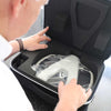 A man looks at the Hark Reader in its carry case.