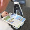 The Hark AI reader scanning a travel magazine