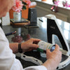 Man using the Hark AI Reader to scan information on a tin of food
