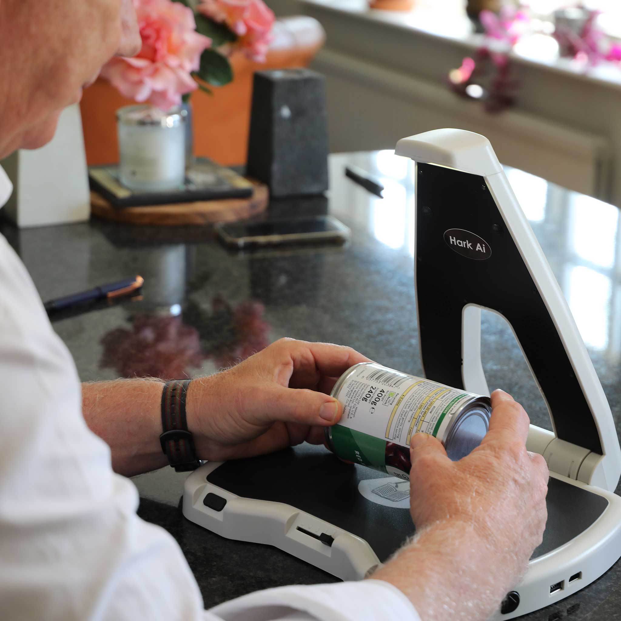 Man using the Hark AI Reader to scan information on a tin of food