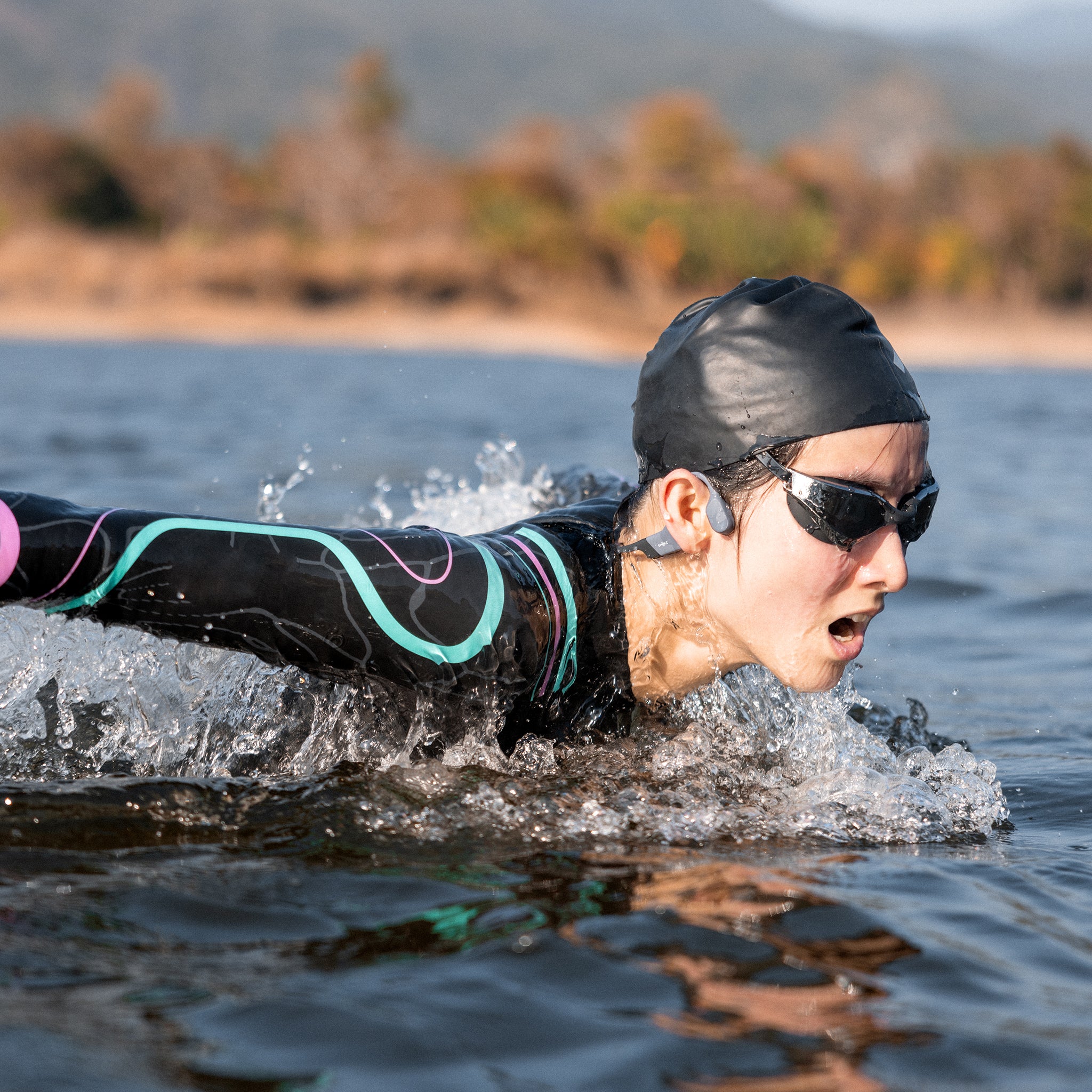 A person swimming using the OpenSwim Shokz.