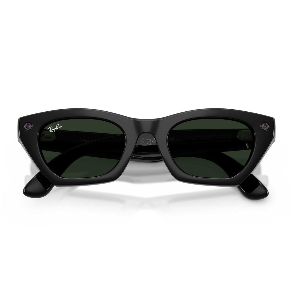 A pair of black smart glasses with green lenses in the folded position against a white background.