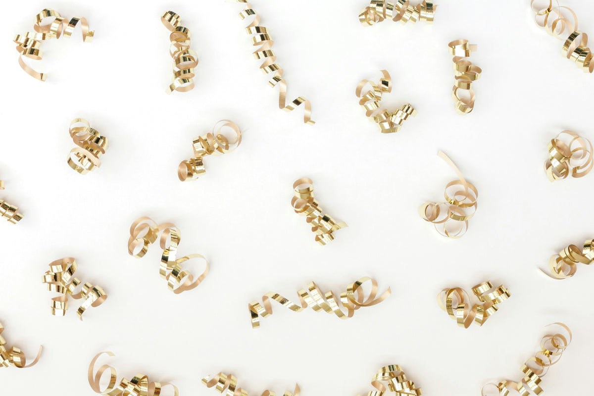 Decorative gold curling ribbons on a white background, suggesting a celebratory offer.