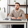 A person sitting at a desk using the Brailliant BI40X