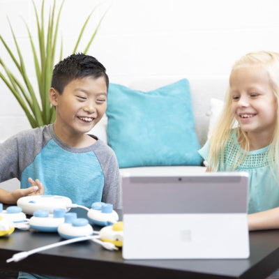 Young boy and girl working together using Code Jumper.