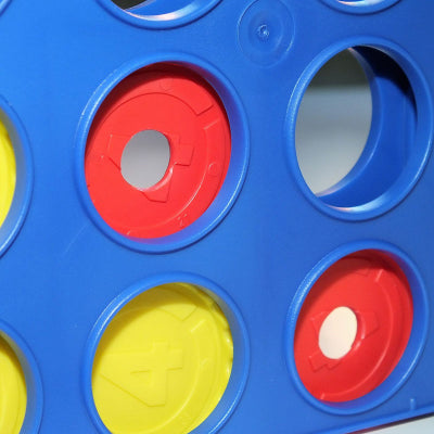 Close up of yellow and modified red discs in the Connect 4 grid