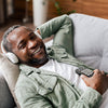 Lifestyle image shows man  with product on a sofa