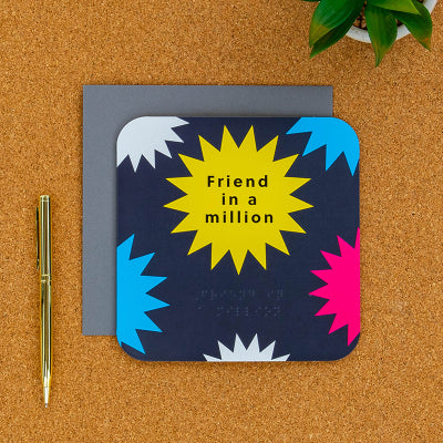 Friend in a million card on a desk with pen next to it