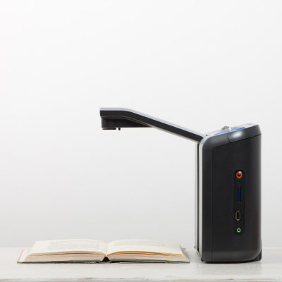 Side view of an Optelec ClearReader+ Portable ImageReader with arm extended with a book underneath