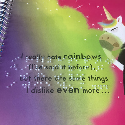 Unicorns don't love sparkles page showing print and braille