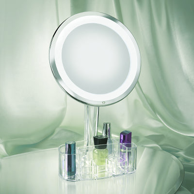 Aphrodite mirror against a green satin background