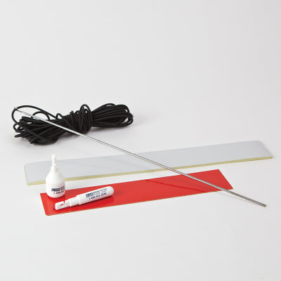 White reflective tape, red reflective tape and elastic cord on a table top