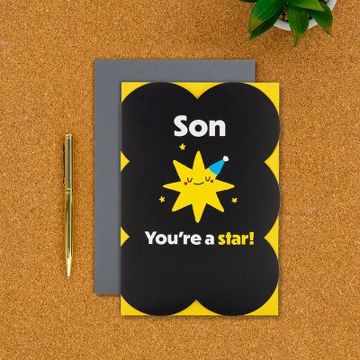 Son birthday card on a desk with pen next to it