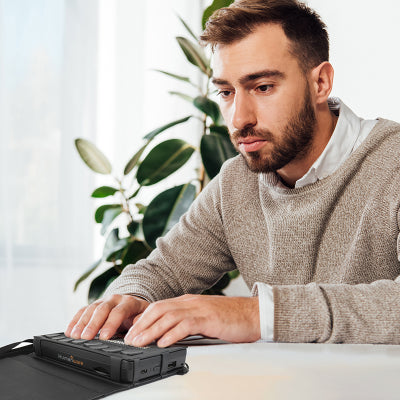 Front view of a person using the Brailliant BI20X on a desk