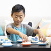 Child's hand turning the dials on the Play pod.