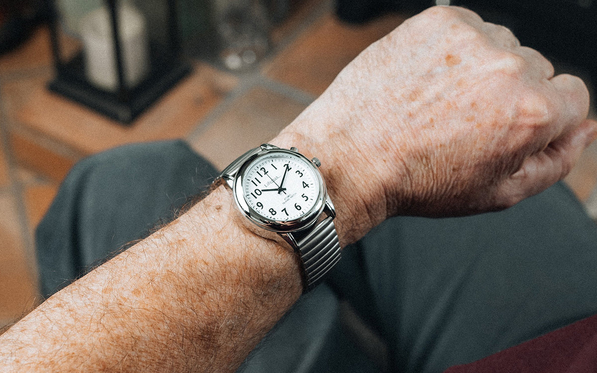 A radio-controlled watch with bracelet strap on a man's wrist