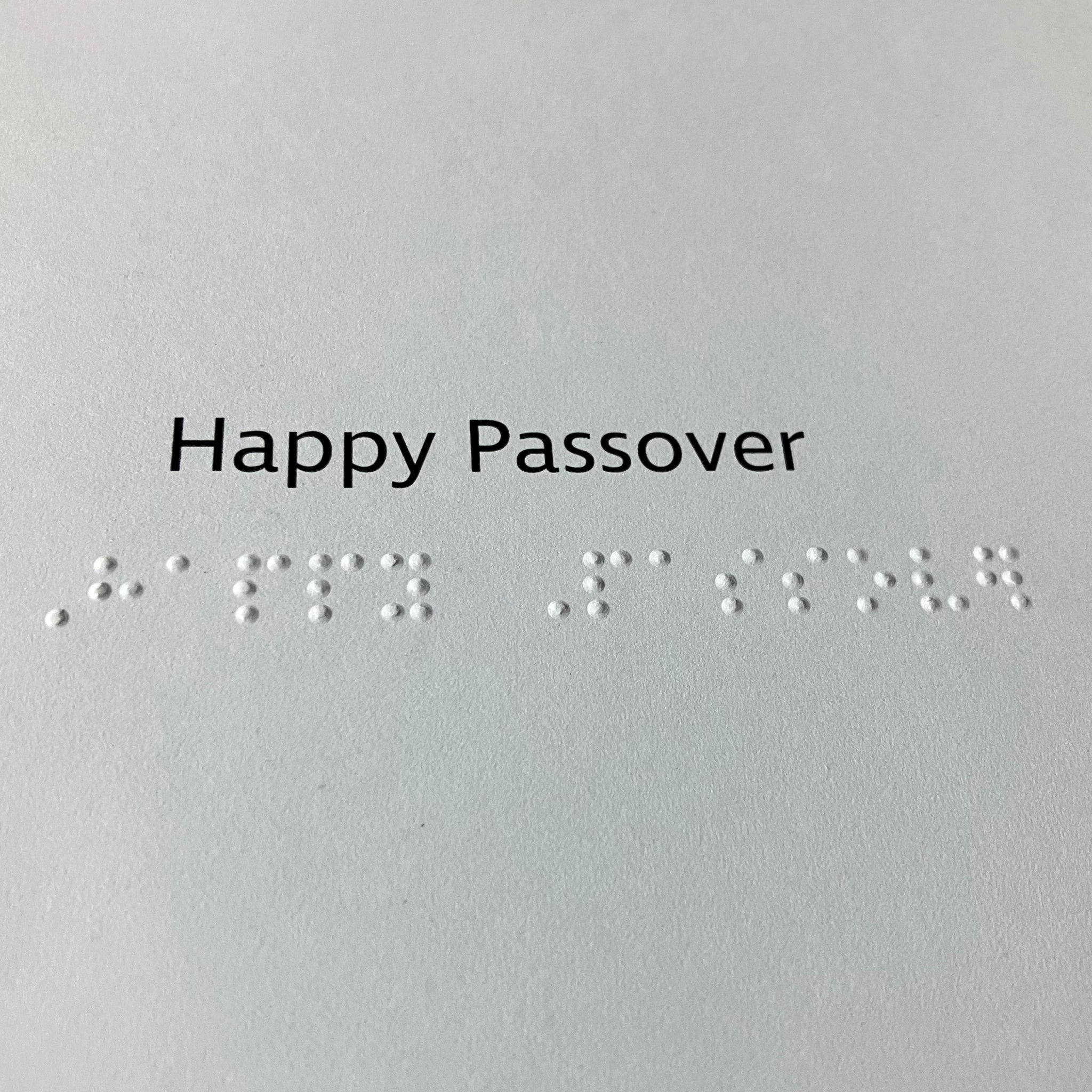 Text and braille 'Happy Passover' on the inside of the card.