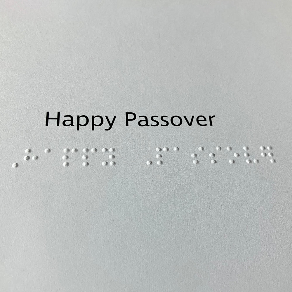 Text and braille 'Happy Passover' on the inside of the card.