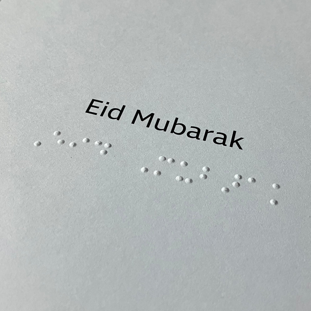 Inside card with 'Eid Mubarak' in Braille text