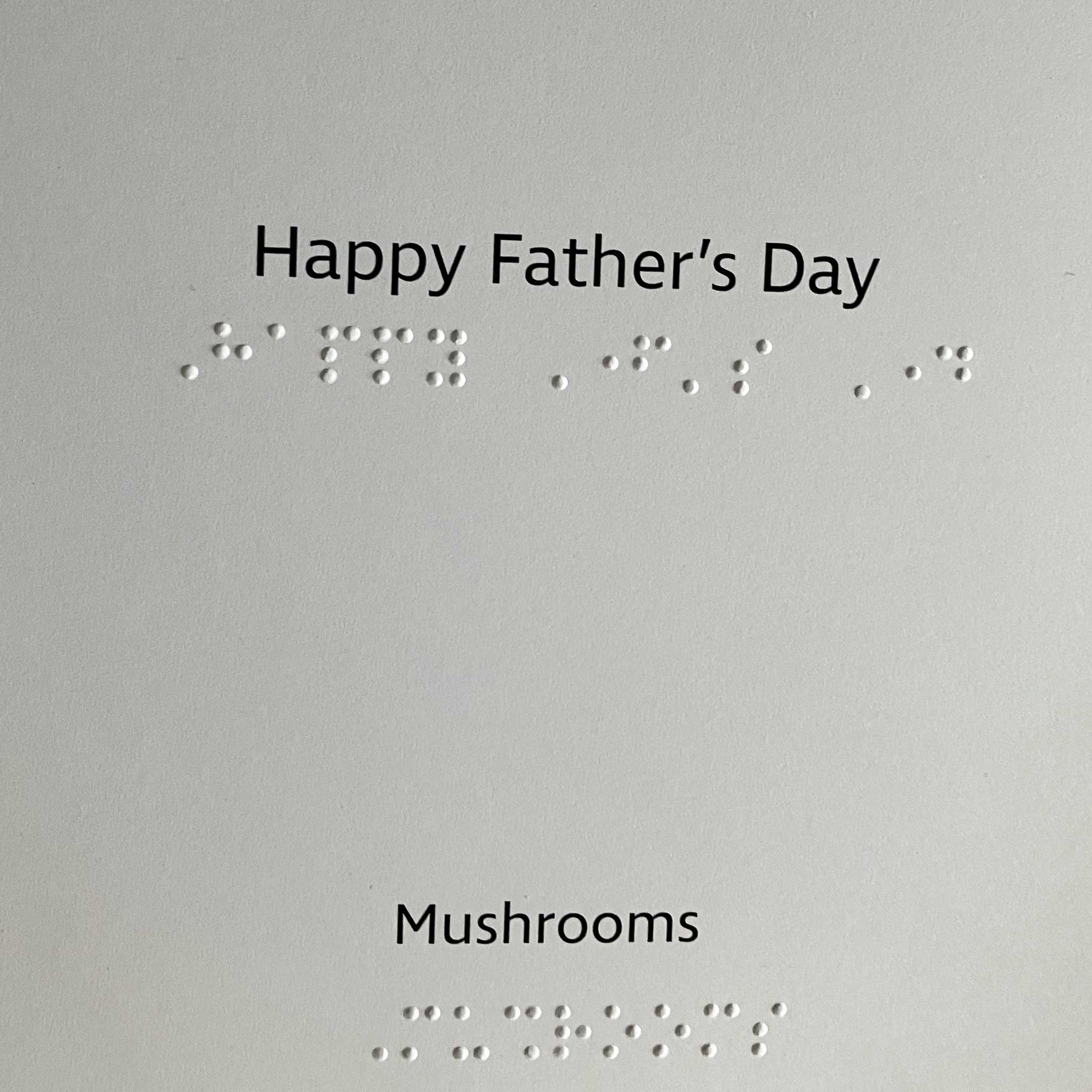 Inside of the card reads "Happy Father's Day" and "Mushrooms" in both print and braille.