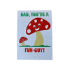 Card with a mushroom design and text and braille 'Dad, you're a fun-guy!' on a light background. 