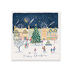 A festive illustrated winter village scene with colorful houses, a decorated Christmas tree, small people walking and gathering, shooting stars in the night sky, and the words 'Happy Christmas' at the bottom.