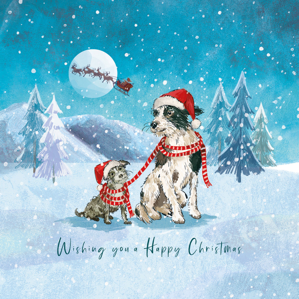A festive Christmas illustration featuring two dogs in a snowy winter landscape, both wearing Santa hats and red-and-white striped scarves. One dog is tethered to the other, and a full moon with Santa's sleigh is visible in the sky.