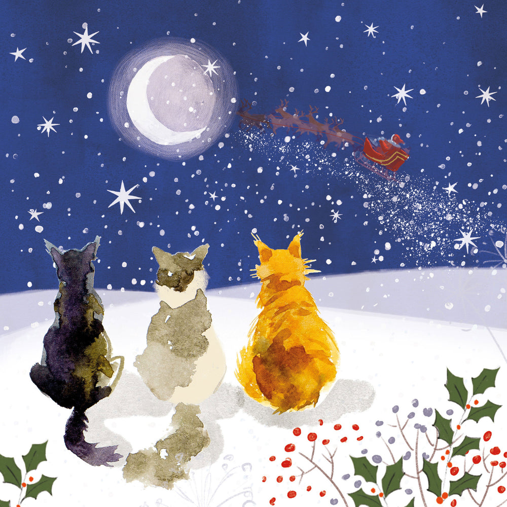 Watercolor-style illustration of three cats sitting in a snowy landscape under a night sky, watching a glowing moon and a red Santa Claus sleigh leave across the snow. Holly and berries appear in the foreground.