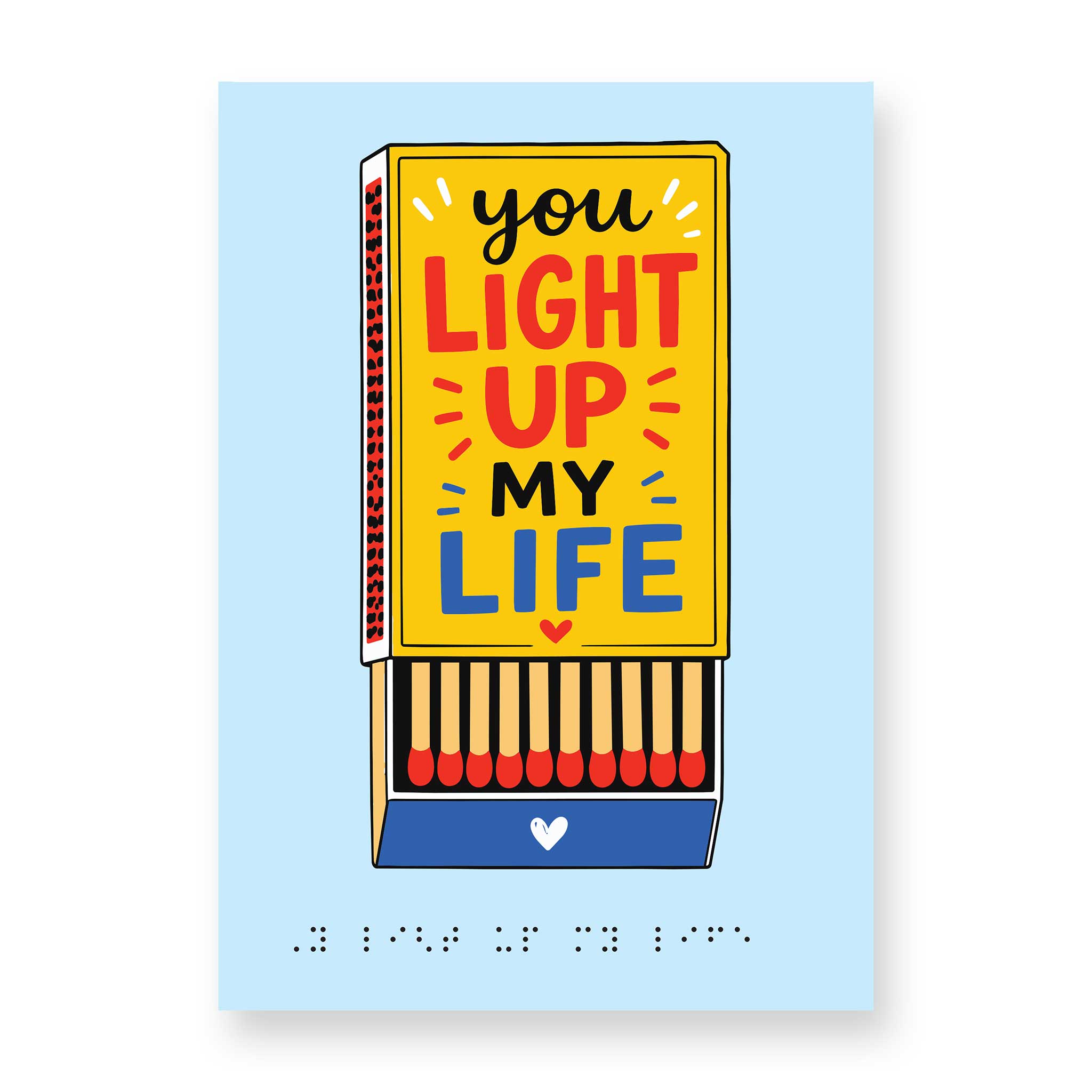 Pale blue greeting card with a golden yellow matchbox carrying the message 'you light up my life' in large black, red and blue text and the drawer open to show matchsticks inside. Message repeats in braille at the bottom of the card