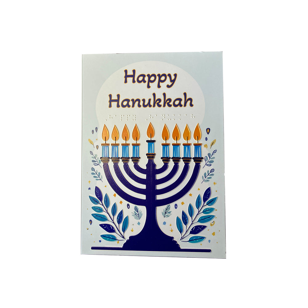 Front of Happy hanukkah card with lit blue menorah and braille greeting