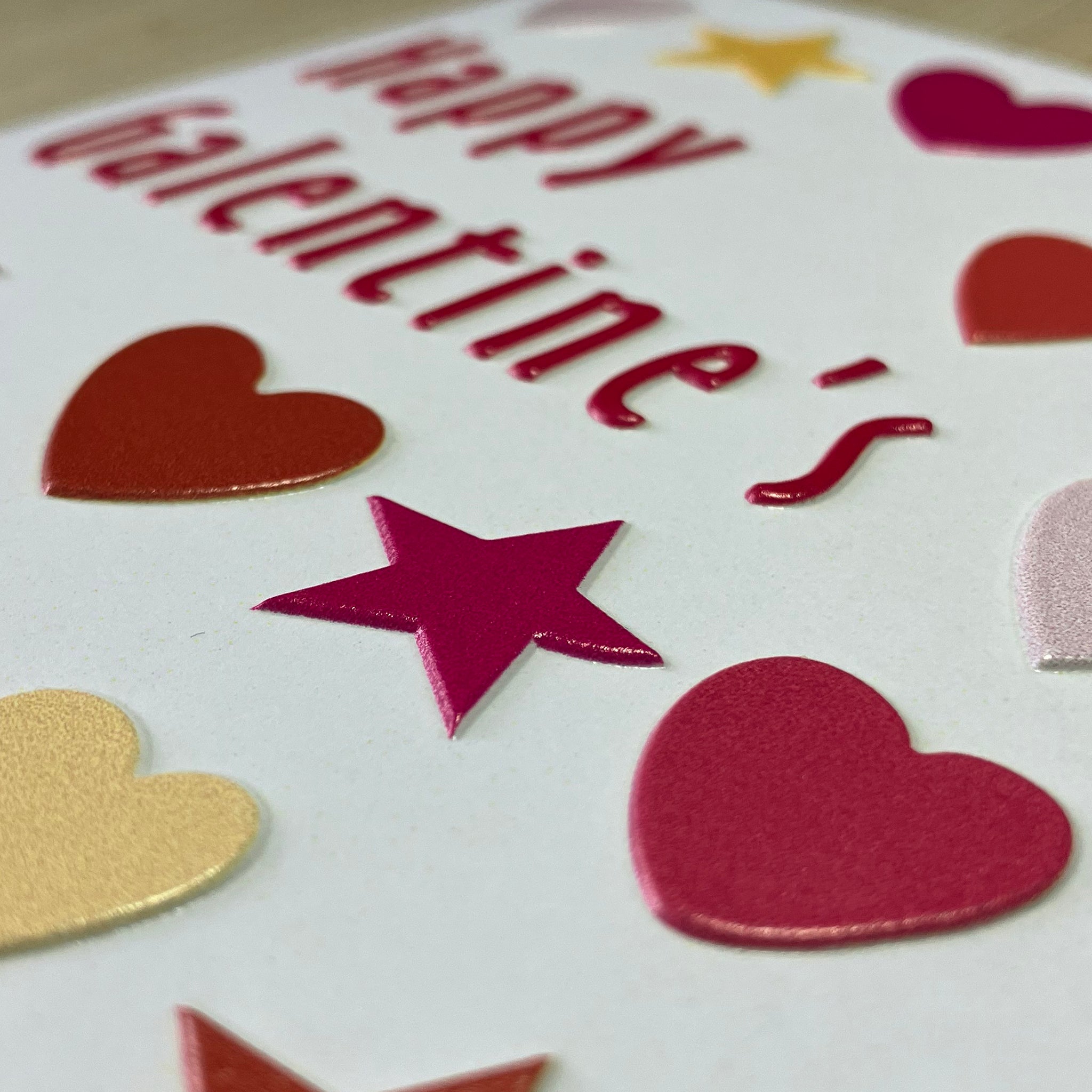 Close-up of tactile letters, hearts and stars on front of the Galentine's Day card